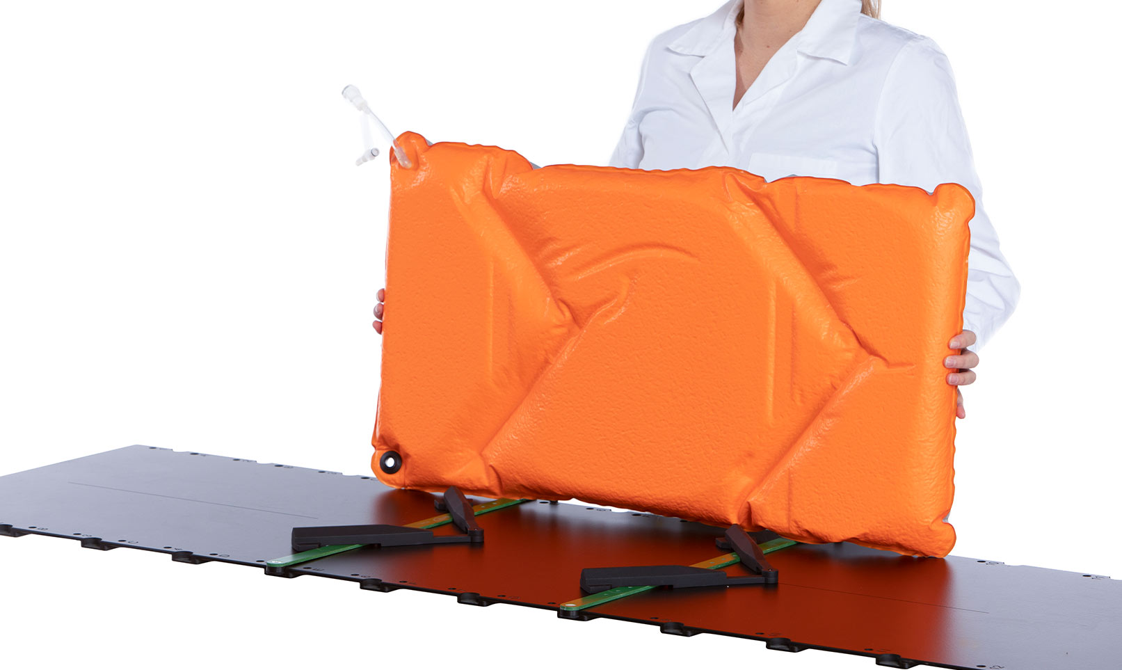 Woman holding an Orange Orfit Vacuum Bag over a couchtop with two indexing bars.